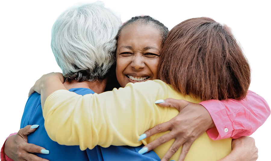 Three smiling women embracing and supporting one another